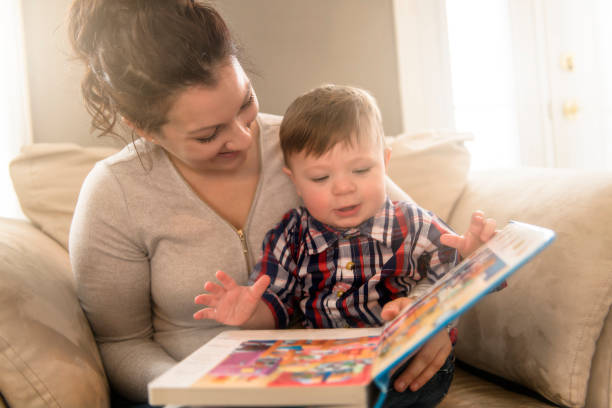 istock Mother reading book with her child on sofa 1078479124