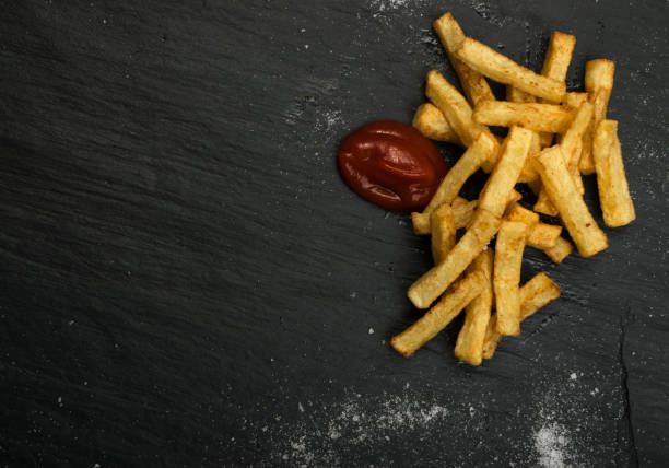 istock French Fries with Ketchup on Dark Background 1078480632