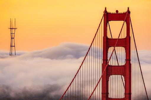 Top of Golden Gate Bridge and Sutro Tower over the clouds in the morning. San francisco, California. USA