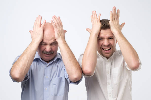 istock Two men, father and son, slap themself on head 1078481898