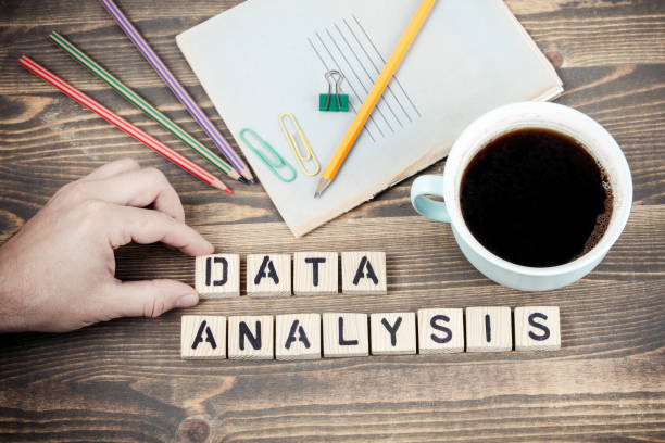istock Data Analysis. Wooden letters on the office desk 1078482700