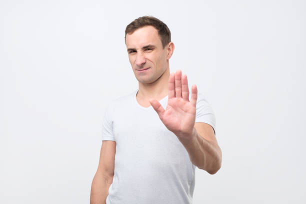 istock Young italian man shows stop timeout or refusal sign with hand 1078484288
