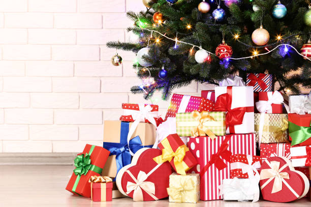 istock Christmas tree with decorations and gift boxes on brick wall background 1078485318