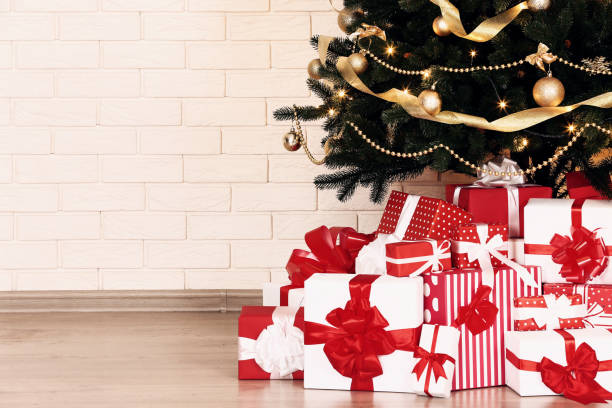 istock Christmas tree with decorations and gift boxes on brick wall background 1078485794