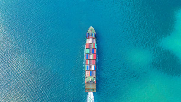 istock Container ship in export and import business and logistics. Shipping cargo to harbor by crane. Water transport International. Aerial view and top view. 1078487574