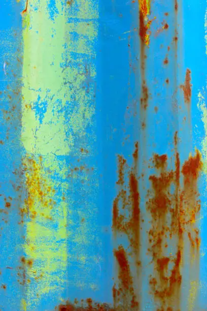 Rusted metal surface seablue and yellow of a sea container
