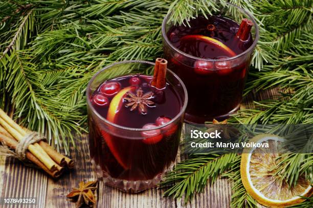 Christmas Mulled Wine With Cranberries In Glasses Winter Warming Drink With Spices Decorated With Fir Branches Cinnamon Dried Oranges Stock Photo - Download Image Now