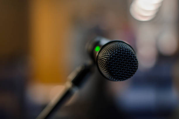 istock black microphone. on air. close-up. public speech. speaker. conference room 1078494780