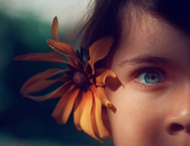 Caucasian woman with brown eyes with yellow flowers wreath around her head
