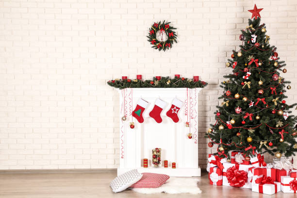 istock White decorated fireplace with christmas tree on brick wall background 1078504032