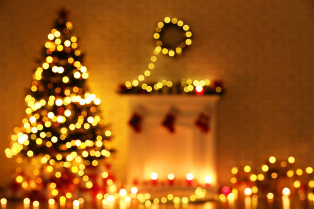istock Blurred background of decorated fireplace near christmas tree 1078504132