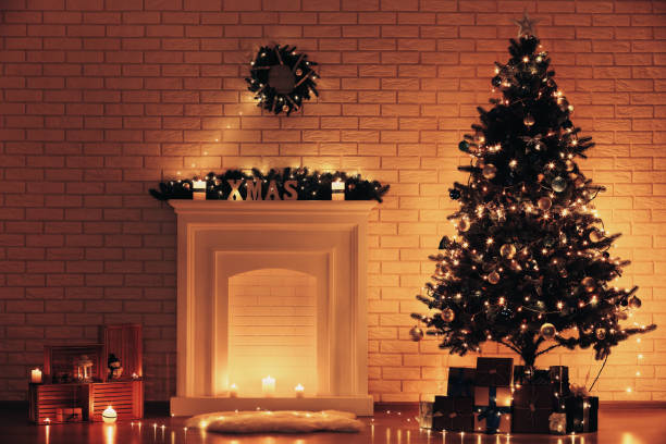 istock White decorated fireplace near christmas tree on brick wall background 1078504360