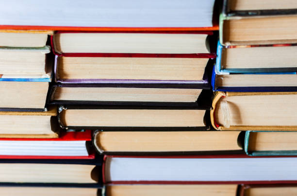 istock Books background, glasses and notebook on white wooden table 1078504886