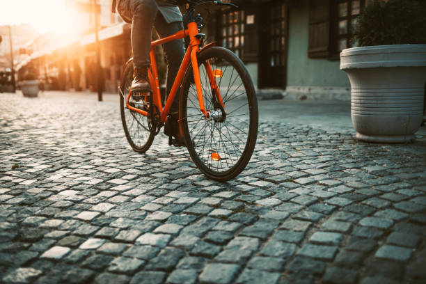 Young, urban cyclist riding his bicycle on the way to work