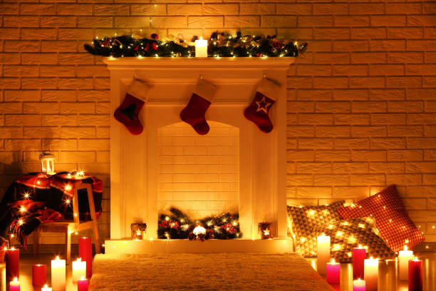 istock White decorated fireplace with stocking socks on brick wall background 1078505424