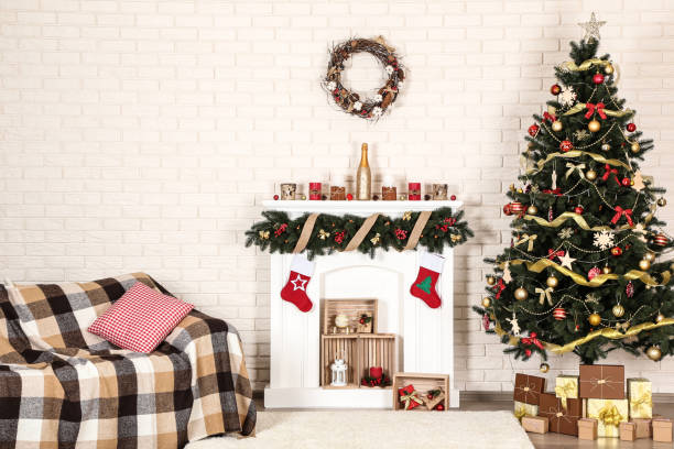 istock White decorated fireplace near sofa and christmas tree on brick wall background 1078507224