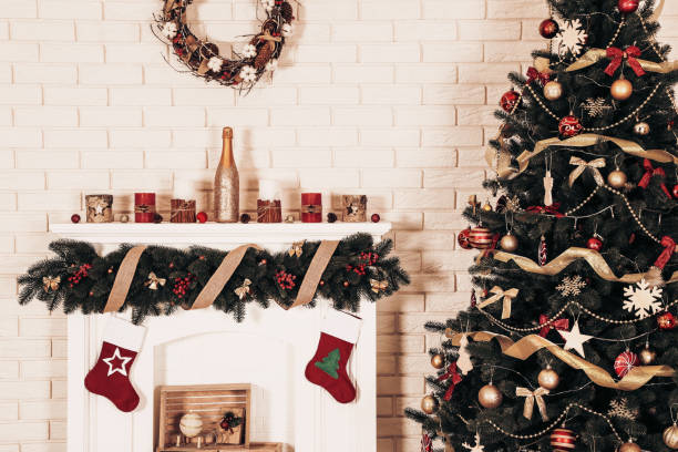 istock Decorated fireplace near christmas tree on brick wall background 1078507258