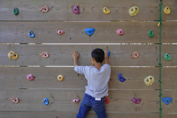 istock Japanese boy playing with bouldering (third grade at elementary school) 1078507460