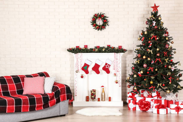 istock White decorated fireplace near sofa and christmas tree on brick wall background 1078507978