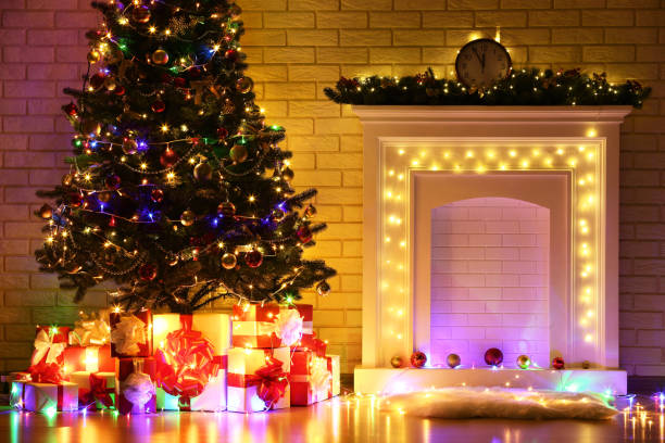 istock White decorated fireplace near christmas tree on brick wall background 1078508146
