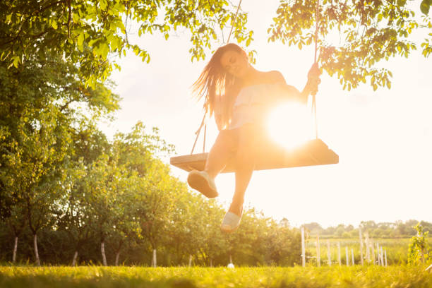 istock Beautiful woman enjoying on a swing 1078509884