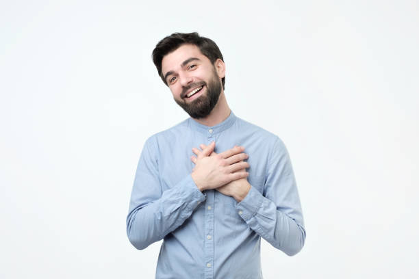 istock Cheerful hispanic man smiles happily, keeps hands on chest, expresses his positive emotions. 1078513608