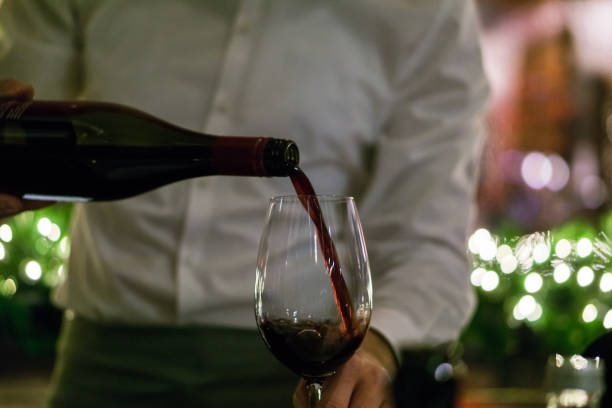 istock Photo of waiter serving red wine 1078515854
