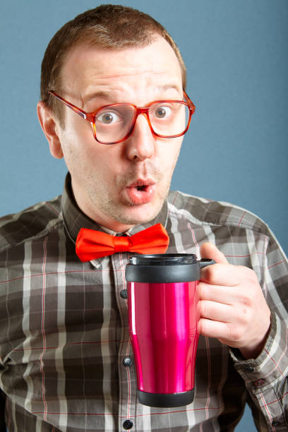 istock Successful nerd guy holding mug with hot drink 1078522328