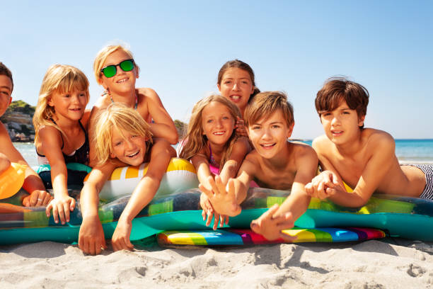 istock Happy friends sunbathing on sandy beach in summer 1078526356