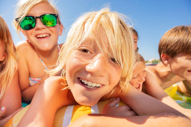 istock Boy and his friends spending vacation on the beach 1078526398