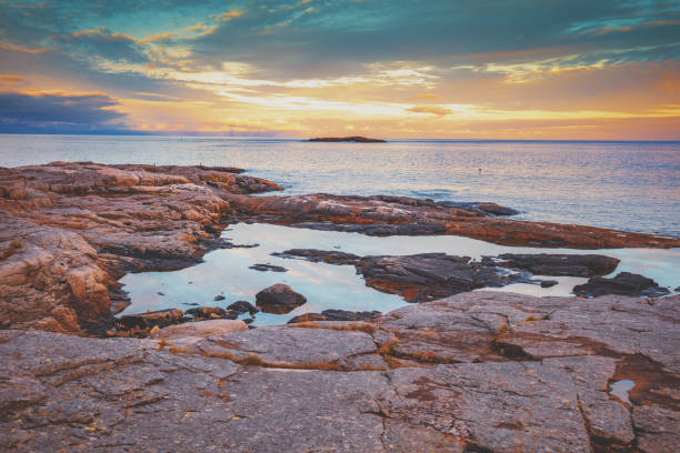 istock Rocky sea shore at sunset 1078526472
