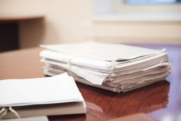 Pile of unfinished documents on office desk, Stack of business paper. stock photo