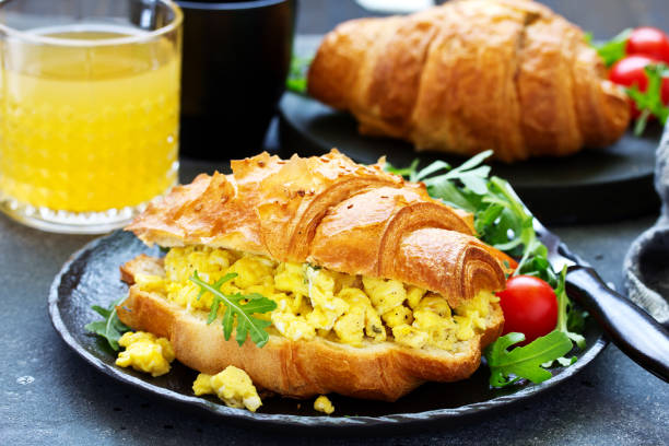istock Breakfast of croissant with scrambled eggs and salad. 1078533964