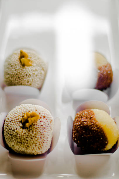 Porcelain tray with brigadeirtos, Brazilian sweets. Selective focus. Background blurred.