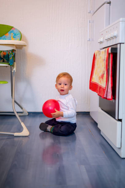 istock crawling baby boy playing with balloon at home 1078536530
