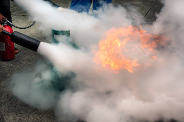 istock Man teaches how to use fire extinguisher to extinguish fire. 1078536674