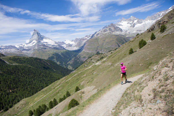 istock Woman running on a mountain trail 1078537568