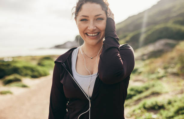 istock Cheerful female runner standing outdoors 1078540146
