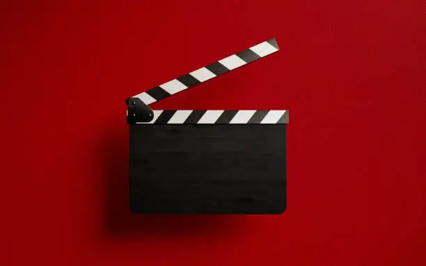 Blank film slate isolated on red background. Horizontal composition with copy space.