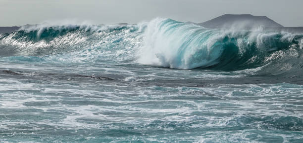 istock Turquoise tunnel wave strike against shallow water. 1078545668