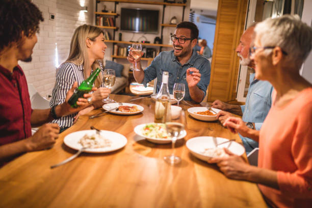 istock Cheerful family having fun while eating dinner at home 1078545750