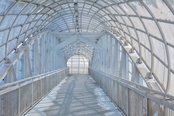 istock long white corridor of metal structures and glass 1078545982
