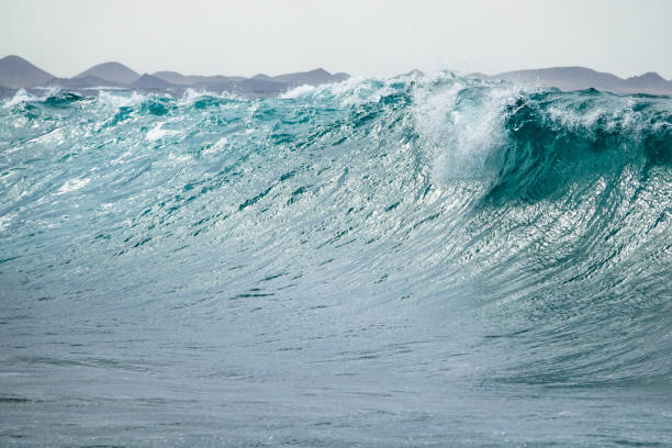 istock Turquoise giant wave strike against shallow water before it breaks. 1078545996