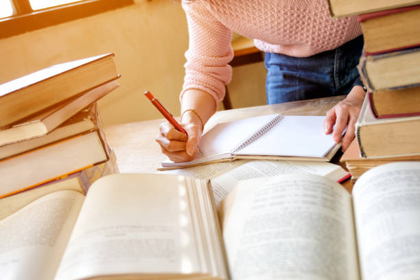 istock Young woman studying in a library 1078548440