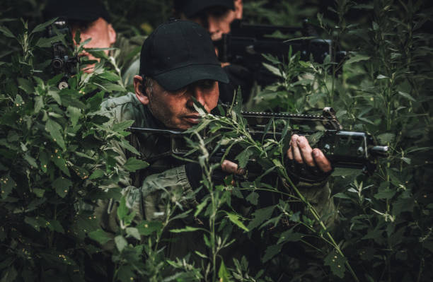 istock Military men hiding in bushes 1078548510