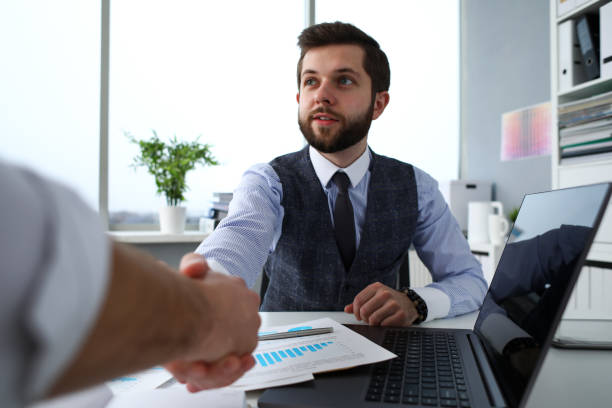 istock Man in suit and tie give hand as hello in office 1078548704