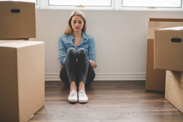 istock A depress woman with box at home 1078548822