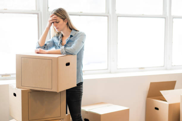 istock A depress woman with box at home 1078549112