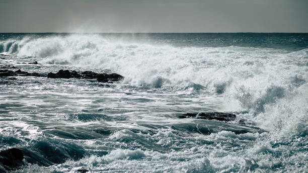 istock Stormy waves strike against rocky shallow water. 1078549202