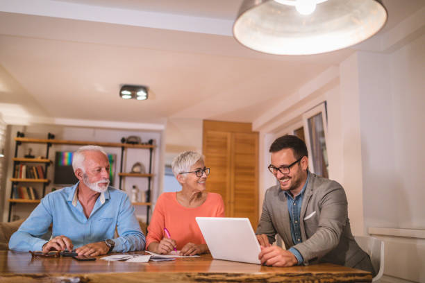 istock Young accountant helping a senior couple with finances 1078550510